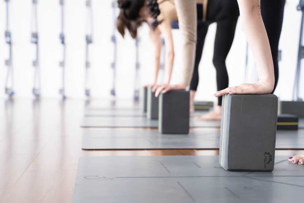 women leaning on solid blocks in exercising